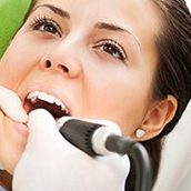 A dentist using a Diagnodent tool to detect cavities in her patient