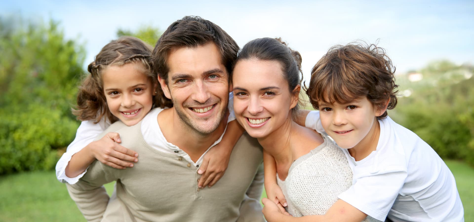 A happy family smiling into the camera